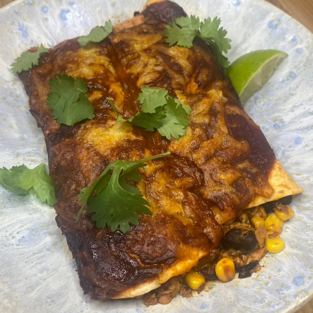 Chicken enchiladas with black beans & corn, fire roasted red pepper & achiote sauce