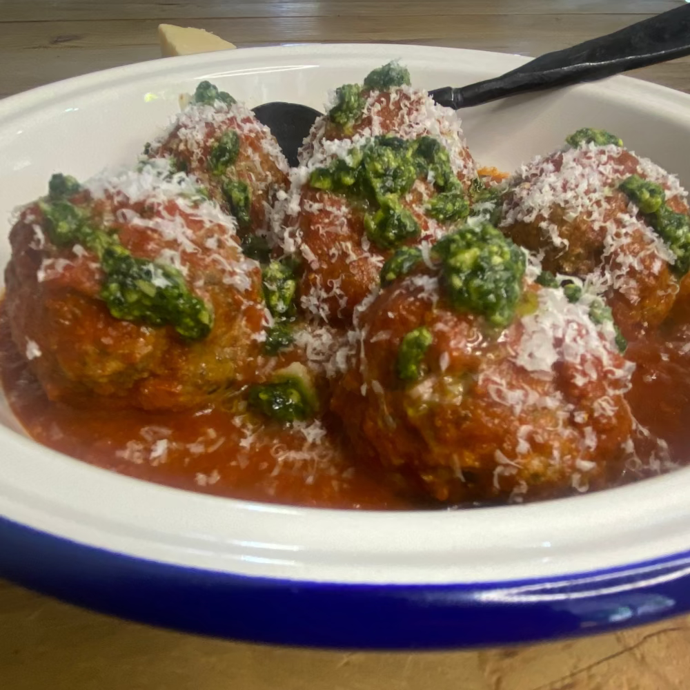 Big Italian meatballs with tomato sauce, pesto & parmesan