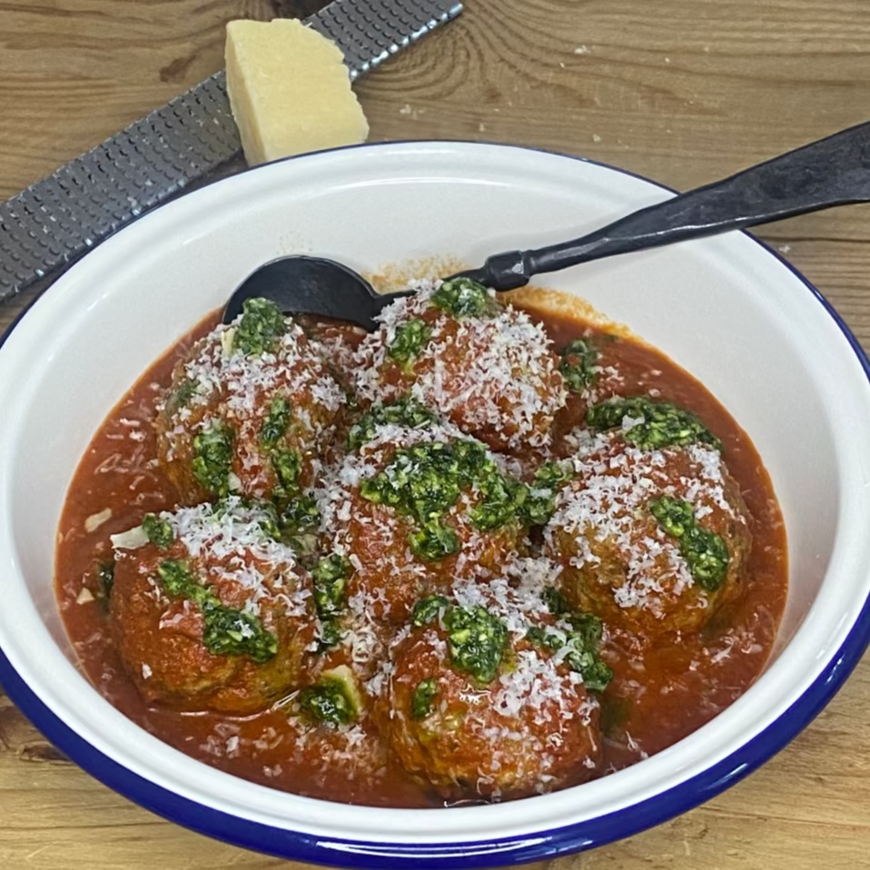 Big Italian meatballs with tomato sauce, pesto & parmesan