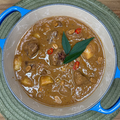 Slow-cooked beef cheek Massaman curry with tender potatoes in a rich, aromatic coconut curry sauce.