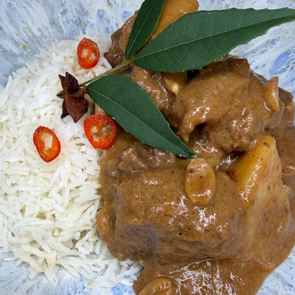 Slow-cooked beef cheek Massaman curry with tender potatoes in a rich, aromatic coconut curry sauce with Jasmine rice