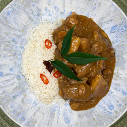 Slow-cooked beef cheek Massaman curry with tender potatoes in a rich, aromatic coconut curry sauce with Jasmine rice