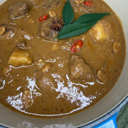 Slow-cooked beef cheek Massaman curry with tender potatoes in a rich, aromatic coconut curry sauce.