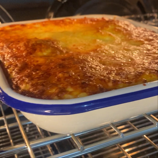 Beef lasagne in the oven with a nice golden cheesy glaze