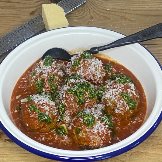 Big Italian meatballs with tomato sauce, pesto & parmesan