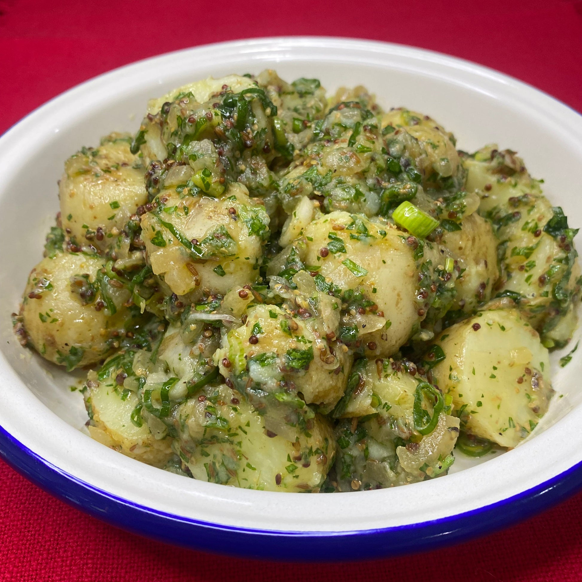 Potato salad with spring onion, slow cooked onion cumin and herbs