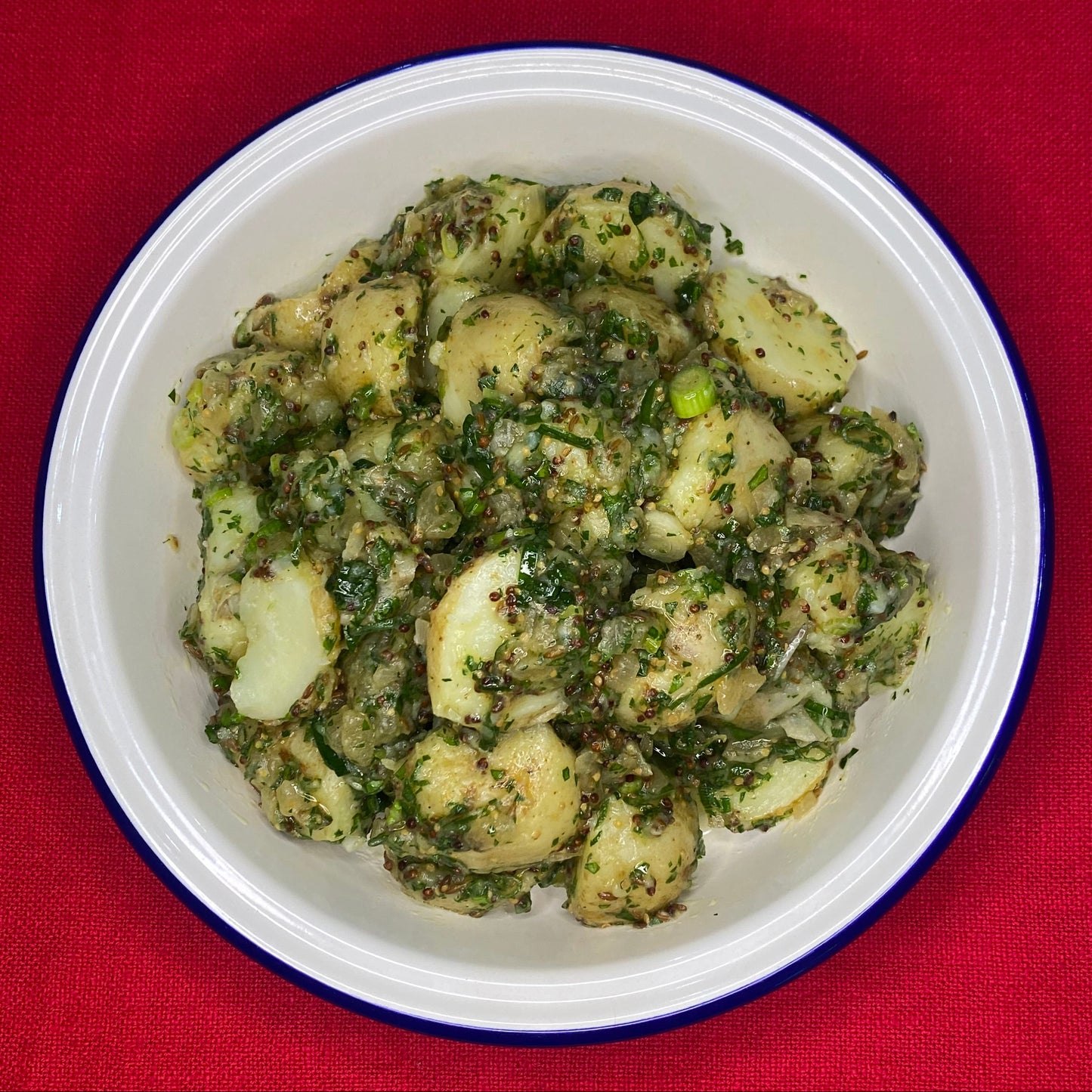 Potato salad with spring onion, slow cooked onion cumin and herbs