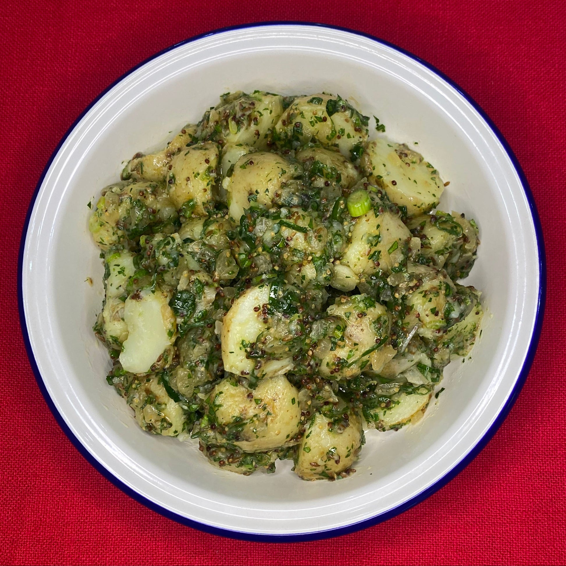 Potato salad with spring onion, slow cooked onion cumin and herbs