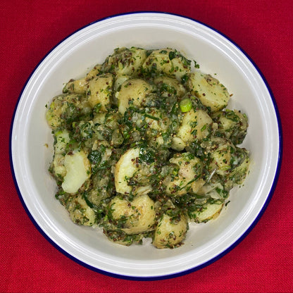 Potato salad with spring onion, slow cooked onion cumin and herbs