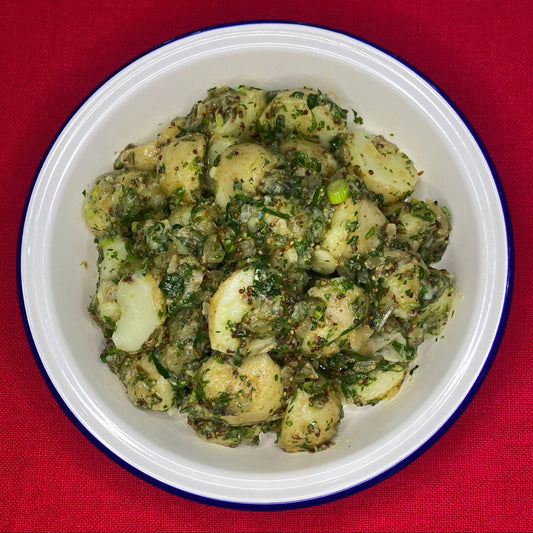 Potato salad with spring onion, slow cooked onion cumin and herbs